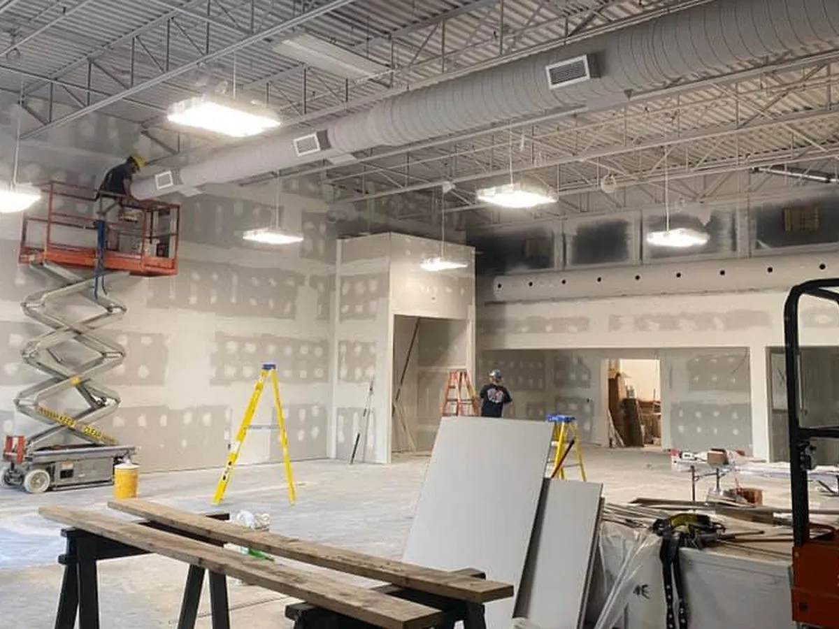 Commercial space under renovation, with a scissor lift
