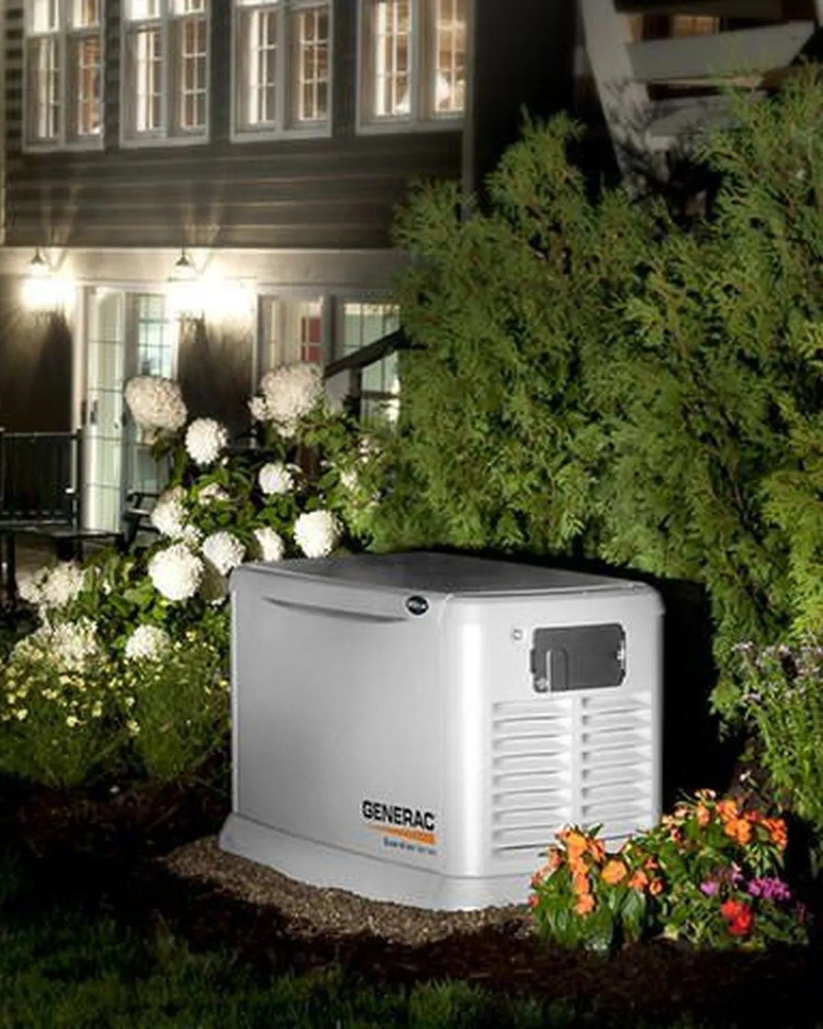 Generac standby generator beside a house at night