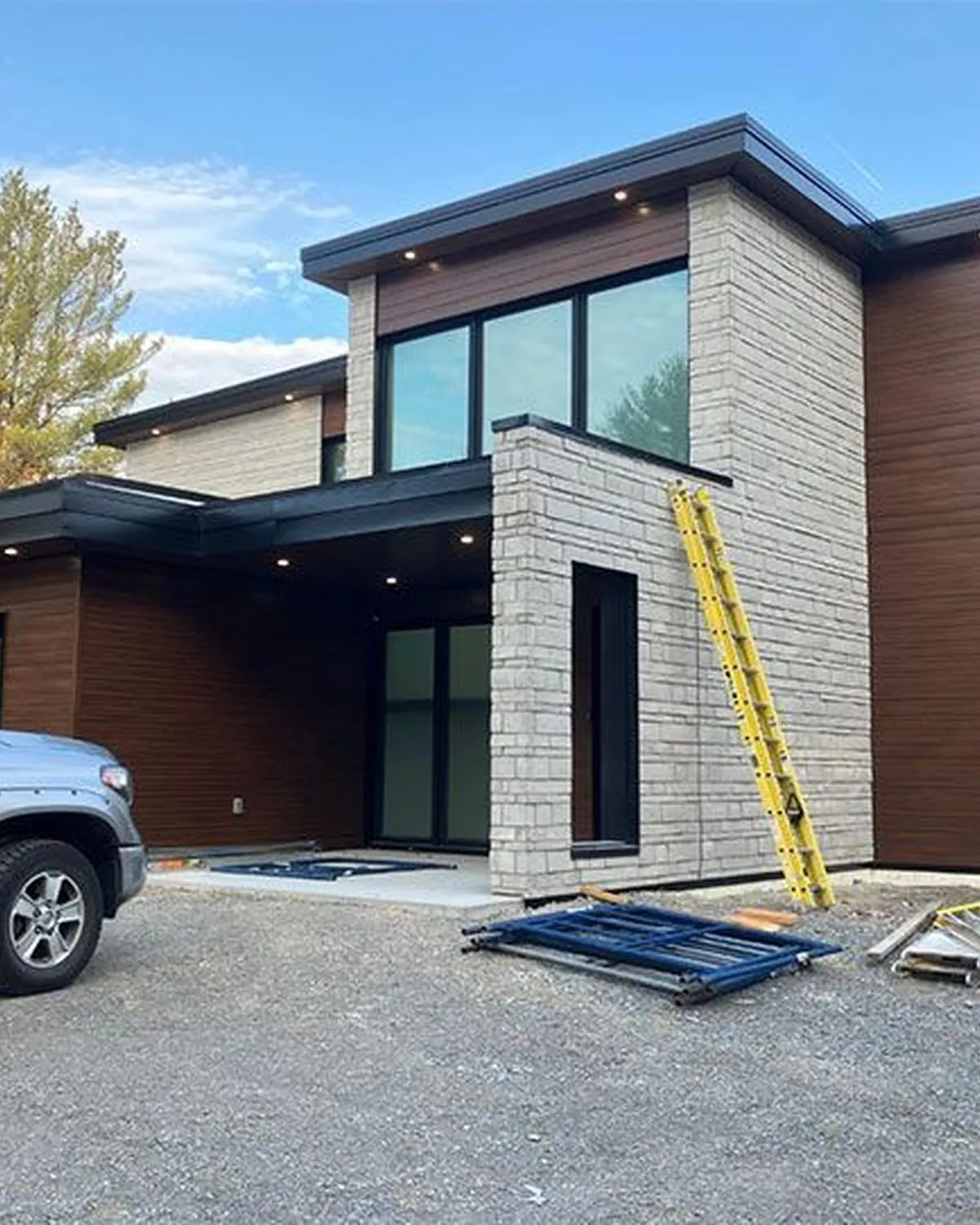 Newly built house with a Tombari Electric truck in the driveway